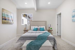 Englewood house for rent - A bedroom with a large bed and a painting on the wall.