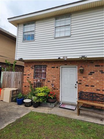 Kenner apartment for rent - A house with a white door and a brick wall.