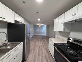 East Point apartment for rent - A kitchen with black appliances and white cabinets.