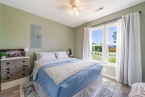 Hubert house for rent - A bedroom with a bed, dresser, and window.