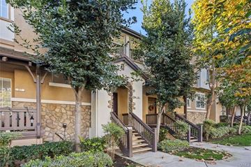 Aliso Viejo apartment for rent - A house with a brown front porch and a stone wall.
