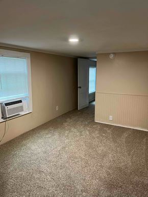 Nacogdoches apartment for rent - A room with a carpeted floor and a window with blinds.