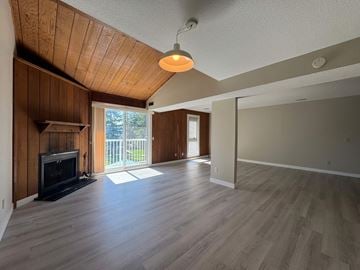Calgary apartment for rent - A living room with a fireplace and sliding glass doors.