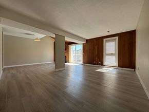 Calgary apartment for rent - A room with wooden floors and a large window.