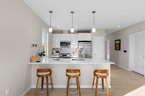 Newark apartment for rent - A kitchen with a white countertop and wooden bar stools.