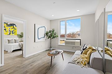 Newark apartment for rent - A living room with a grey couch and a coffee table.