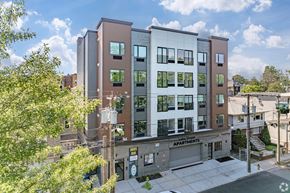 Newark apartment for rent - A modern apartment building with a sign that reads "Apartments".