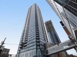 Montreal apartment for rent - A tall skyscraper stands in a cityscape.
