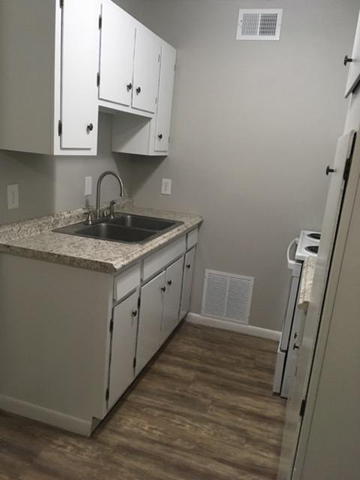 Nacogdoches apartment for rent - A kitchen with white cabinets and a sink.