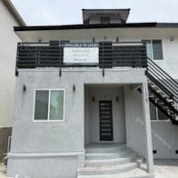 Los Angeles apartment for rent - A grey building with a black roof and a sign that says "Advanced Pacific".
