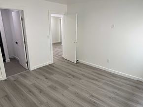 Los Angeles apartment for rent - A room with white walls and wood flooring with two open doors.