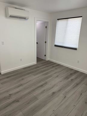 Los Angeles apartment for rent - A room with a wooden floor and a door.