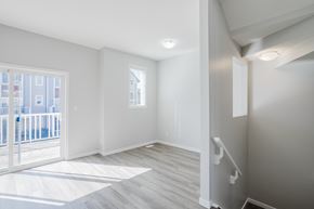 Edmonton apartment for rent - A room with a wooden floor and white walls.