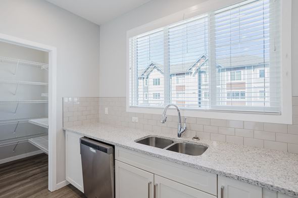 Edmonton apartment for rent - A kitchen with a sink and a window.