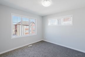 Edmonton apartment for rent - A room with a large window and a view of a building outside.