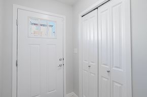 Edmonton apartment for rent - A white door with a window above it and a white door with a handle to the right.