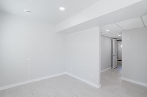 Edmonton apartment for rent - A spacious room with white walls and a tiled floor.