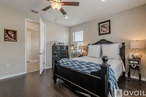 San Marcos condo for rent - A bedroom with a large bed and a ceiling fan.