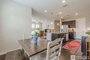 San Marcos condo for rent - A kitchen with a table and chairs in the foreground and a refrigerator in the background.