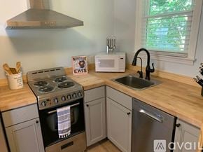Nashville apartment for rent - A kitchen with a stove, sink, and microwave.