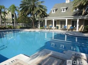 St. Petersburg apartment for rent - A large swimming pool in front of a house with a sign that says "available".