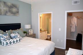 St. Petersburg apartment for rent - A bedroom with a bed, nightstand, and a painting on the wall.