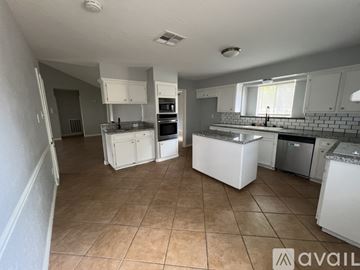 Houston house for rent - A kitchen with white cabinets and appliances is available for rent.