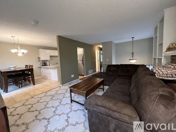 Woodbury house for rent - A kitchen with white cabinets and a tiled floor.