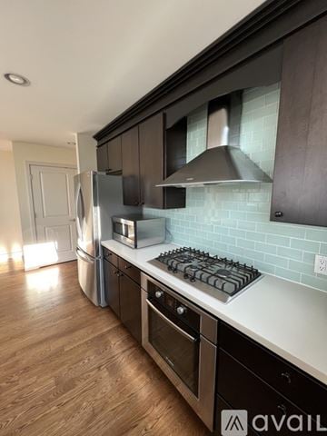 Seattle other for rent - A kitchen with a stove top oven and a refrigerator.