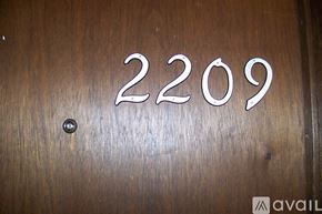 Pekin house for rent - A wooden surface with the number 2209 engraved on it.
