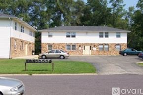 Pekin house for rent - A stone building with a car parked in front.
