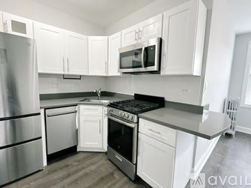 Chicago apartment for rent - A kitchen with white cabinets and stainless steel appliances.
