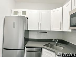 Chicago apartment for rent - A kitchen with a stainless steel refrigerator, microwave, and sink.