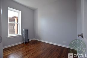Chicago apartment for rent - A room with a window and a radiator on the floor.