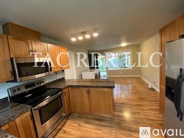 Tacoma apartment for rent - A kitchen with wooden cabinets and a granite countertop.