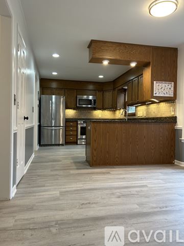 Clemson house for rent - A kitchen with wooden cabinets and a refrigerator.