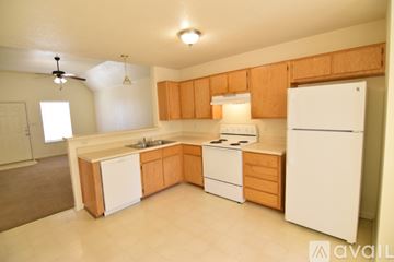 Killeen apartment for rent - A kitchen with wooden cabinets and white appliances.