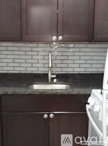 Chicago apartment for rent - A kitchen with brown cabinets and a white oven.