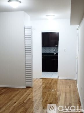 Chicago apartment for rent - A room with wooden floors and a white door.