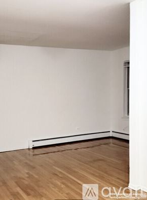 Chicago apartment for rent - A room with wooden flooring and white walls.