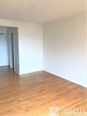 Chicago apartment for rent - A room with wooden flooring and a white wall.