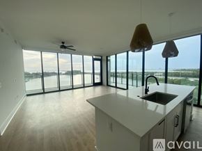 Tampa apartment for rent - A large white building with a pool in front of it.
