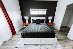 North Hollywood house for rent - A bedroom with a black bed and red curtains.