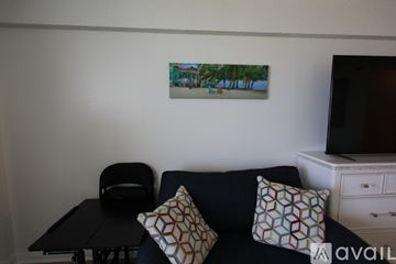 Daytona Beach apartment for rent - A living room with a couch, chair, and a painting on the wall.