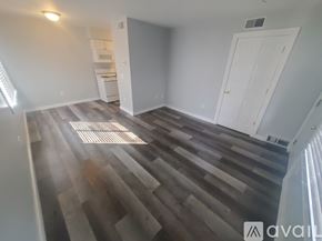 La Crosse apartment for rent - A room with wooden flooring and a white door.