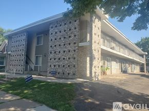 La Crosse apartment for rent - A building with a stone facade and a blue sign in front.
