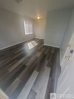 La Crosse apartment for rent - A room with wooden stairs leading to a door.