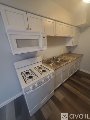 La Crosse apartment for rent - A kitchen with white appliances and cabinets.