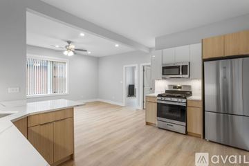 Chicago apartment for rent - A kitchen with wooden cabinets and stainless steel appliances is available for rent.