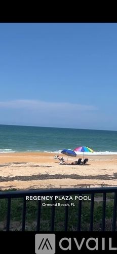 Ormond Beach apartment for rent - A beach scene with a pool and a beach umbrella.